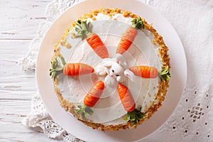 Beautiful carrot cake with candy bunny close-up. horizontal top