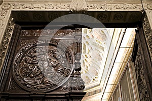 Beautiful carved wood door and stone details of ceiling of the Cathedral of Cuenca