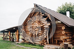 Beautiful carved wooden house in the village of logs and farmyards photo