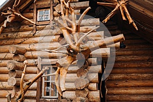 Beautiful carved wooden house in the village of logs and farmyards photo