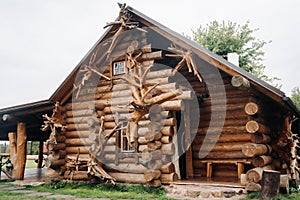 Beautiful carved wooden house in the village of logs and farmyards photo