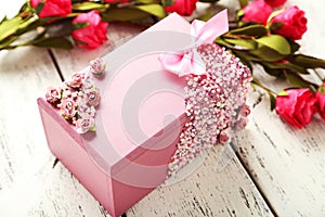 Beautiful casket with flowers on white wooden background