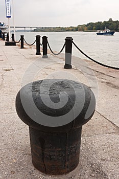A beautiful cast iron tube fastening vessel on the quay at the river port