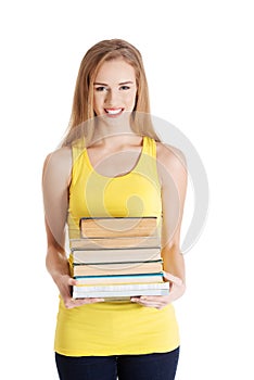 Beautiful casual caucasian woman student holding stack of books.
