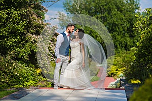 Beautiful casual wedding couple going to kiss