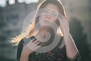 Beautiful caucasian brunette woman on a walk outdoors in park ne