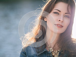 Beautiful caucasian brunette woman on a walk outdoors in park ne