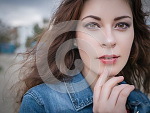 Beautiful caucasian brunette woman on a walk outdoors in park ne