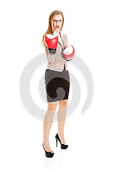 Beautiful caucasian business woman with boxing gloves.