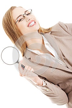 Beautiful caucasian business woman with magnifying glass.