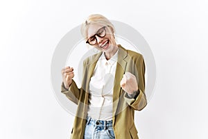 Beautiful caucasian business woman standing over isolated background very happy and excited doing winner gesture with arms raised,