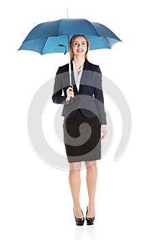 Beautiful caucasian business woman standing under umbrella.