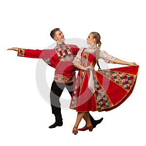 Beautiful caucasian couple dancing in Russian folk costumes isolated on white