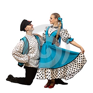 Beautiful caucasian couple dancing in Russian folk costumes isolated on white