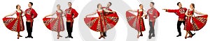 Beautiful caucasian couple dancing in Russian folk costumes isolated on white background