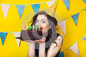 Beautiful caucasian girl blowing candles on her cake. Celebration and party.