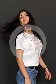 Beautiful caucasian hipster brunette girl posing in studio on isolated background. Trends, style, good time, fashion concept.