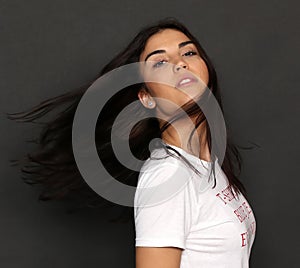 Beautiful caucasian hipster brunette girl posing in studio on isolated background. Trends, style, good time, fashion concept.