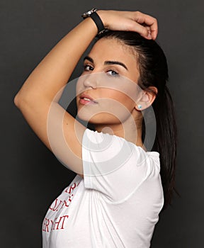 Beautiful caucasian hipster brunette girl posing in studio on isolated background. Trends, style, good time, fashion concept.