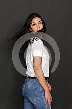 Beautiful caucasian hipster brunette girl posing in studio on isolated background. Trends, style, good time, fashion concept.