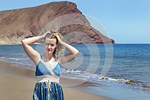 Beautiful Caucasian millennial woman at Playa La Tejita, Tenerife, Canary Islands, Spain photo