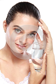 Beautiful caucasian model posing with a glass of water