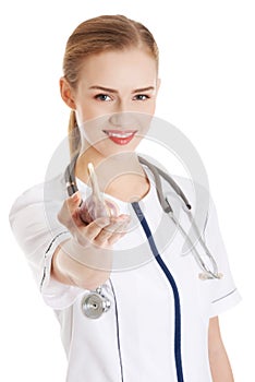 Beautiful caucasian nurse or doctor is holding raw garlic.