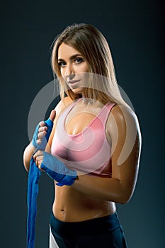 Beautiful caucasian Sweaty boxer woman with blue boxing bandages. photo set of sporty muscular female blonde girl wearing sports c