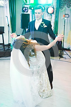 Beautiful caucasian wedding couple just married and dancing their first dance
