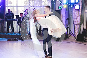 Beautiful caucasian wedding couple just married and dancing their first dance