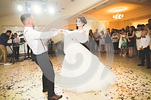 Beautiful caucasian wedding couple just married and dancing their first dance