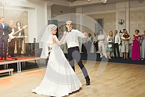 Beautiful caucasian wedding couple just married and dancing their first dance