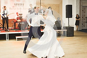 Beautiful caucasian wedding couple just married and dancing their first dance