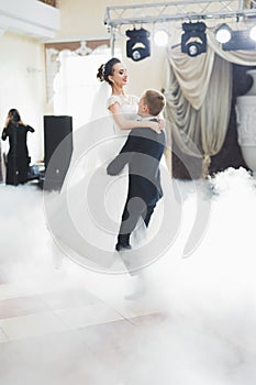 Beautiful caucasian wedding couple just married and dancing their first dance