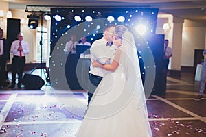 Beautiful caucasian wedding couple just married and dancing their first dance