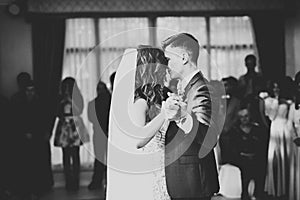 Beautiful caucasian wedding couple just married and dancing their first dance