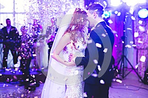 Beautiful caucasian wedding couple just married and dancing their first dance