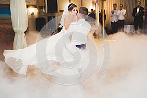 Beautiful caucasian wedding couple just married and dancing their first dance