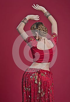 Beautiful caucasian woman with braided hair dressed in Indian bridal Sari along with specific jewelry