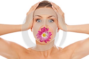 Beautiful caucasian woman with flower in mouth