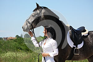 Beautiful caucasian woman and gray horse portrait