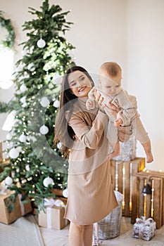 Beautiful caucasian woman holding adorable daughter on hands