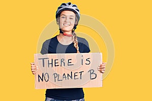Beautiful caucasian woman holding there is no planet b banner looking positive and happy standing and smiling with a confident
