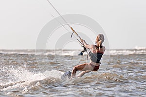 Beautiful caucasian woman kitesurfing isolated on the sea, sexy girl wearing bikini swim wear kiteboarding on the ocean 2021,