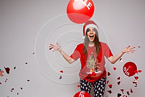 beautiful caucasian woman with a lot of red baloons with sales is surprised