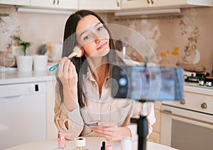 Beautiful caucasian woman making make up and recording video for blog. Blogging concept