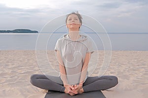 Beautiful caucasian Woman sitting in lotus yoga pose