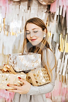 Beautiful Caucasian woman smiles with Christmas presen