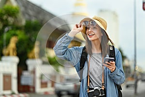 Beautiful caucasian woman traveler with backpack on holiday vacation trip in Thailand. Lifestyle travel and technology