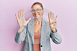 Beautiful caucasian woman wearing business jacket and glasses showing and pointing up with fingers number nine while smiling